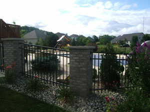 Ornamental iron fence around residential swimming pool